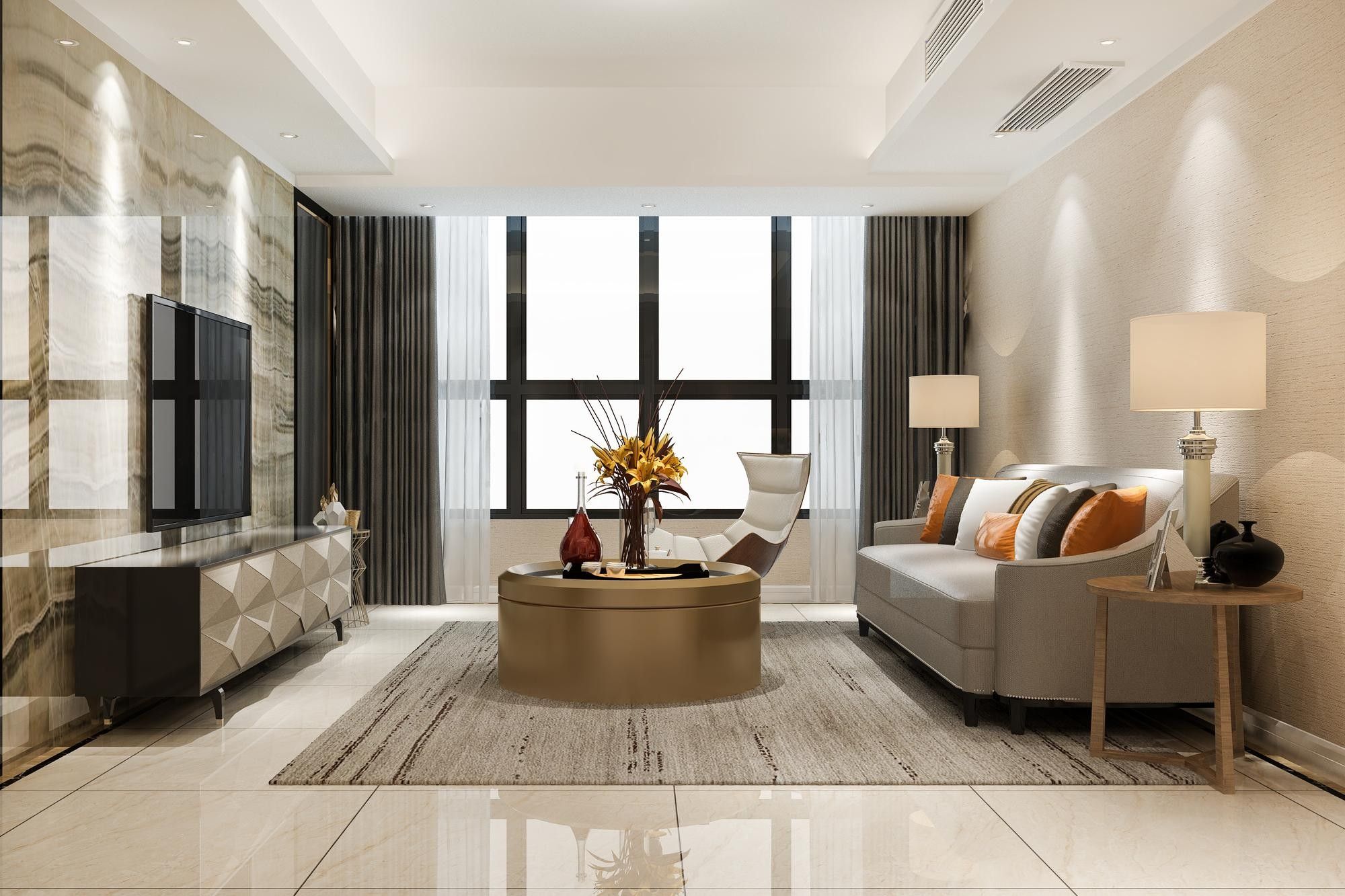 Cream living room with a round coffee table, armchairs and tall windows